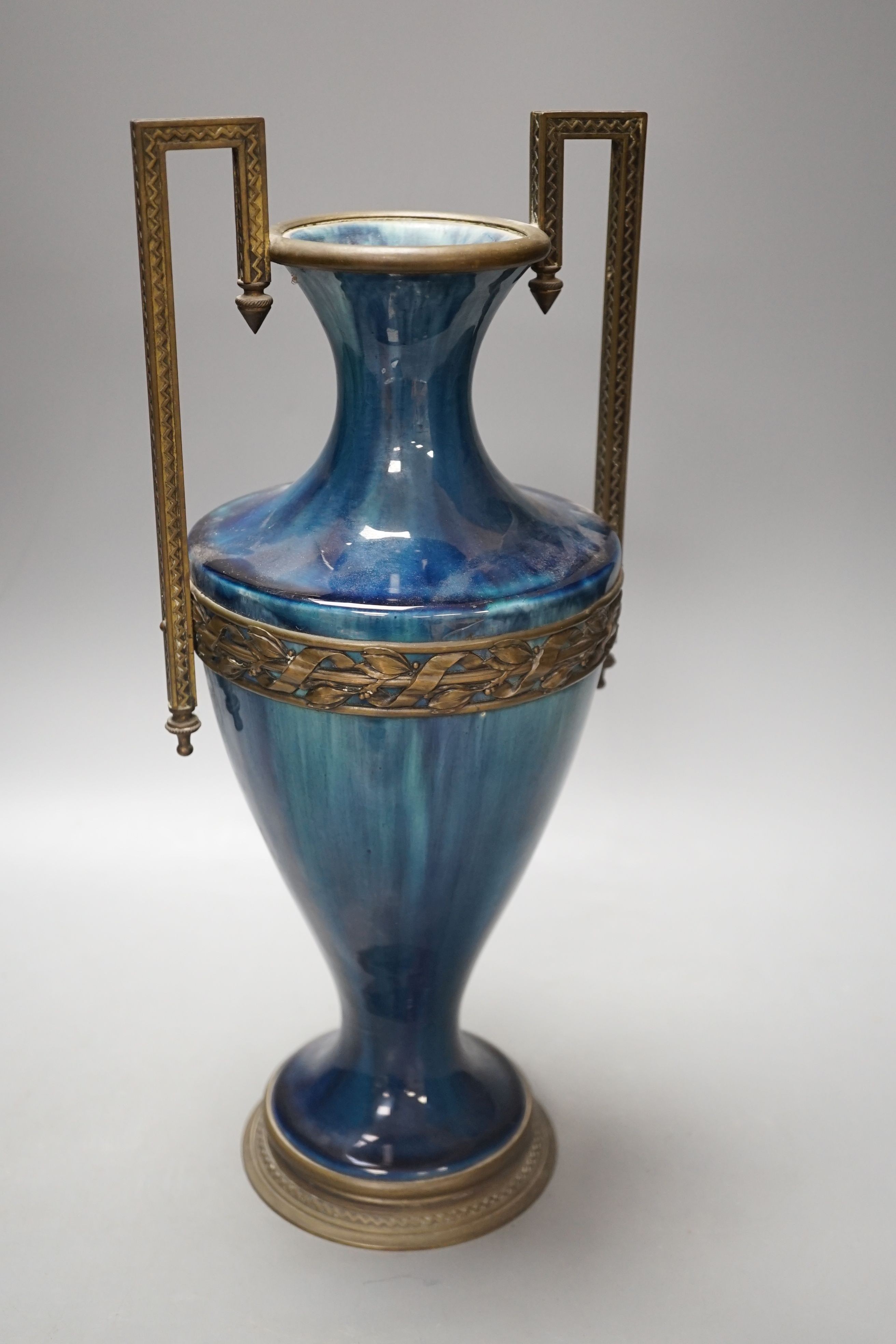 A French blue-glazed vase with embossed metal mounts, c.1900, 37 cms high.